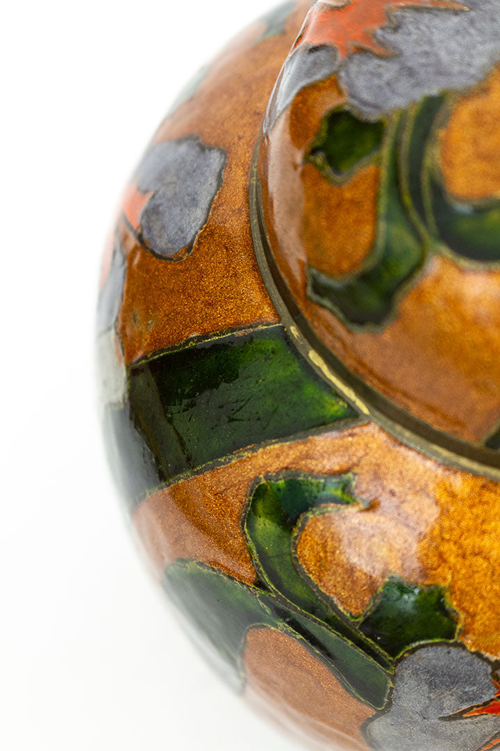 Vintage geëmailleerde oranje gemberpot met orchideeën