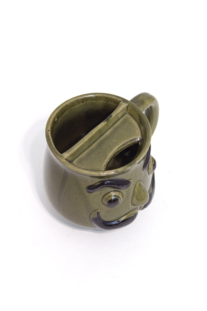 Groene vintage snorrenmok met gezicht