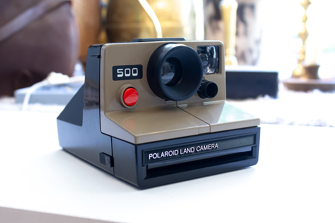 Polaroid 500 Land camera bruine body + flashbar