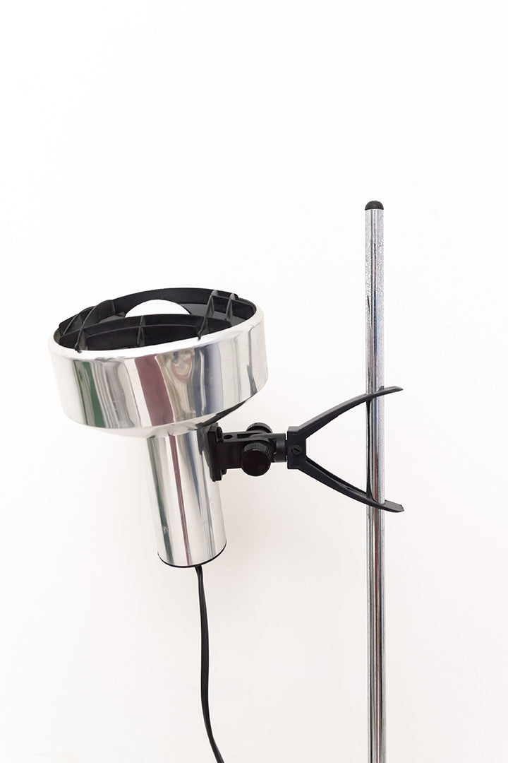 Verchroomde staande lamp met zwart raster in de spot 