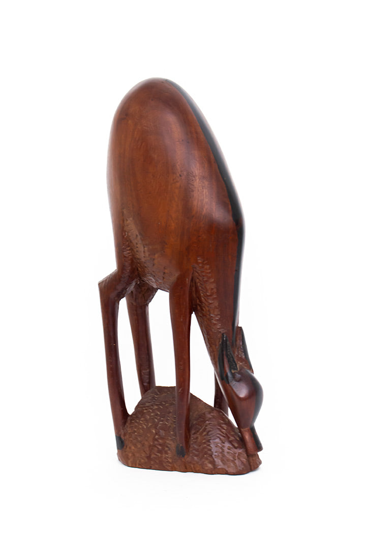 Vintage handgesneden houten beeld van een drinkende hinde