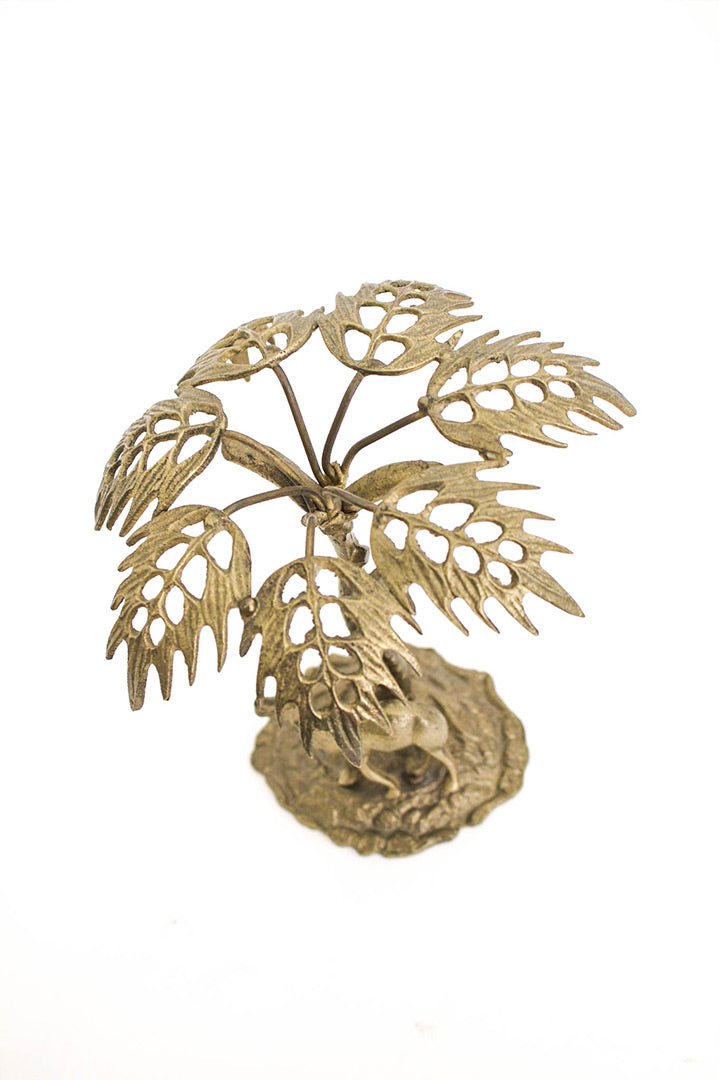 Vintage messing eiland met palmboom en dromedaris