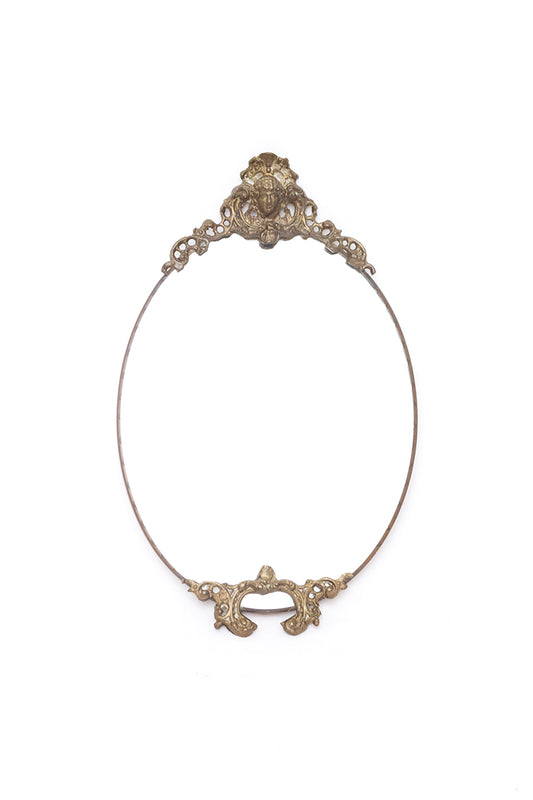 Vintage spiegel ovaal met decoratieve messing rand en hoofdje