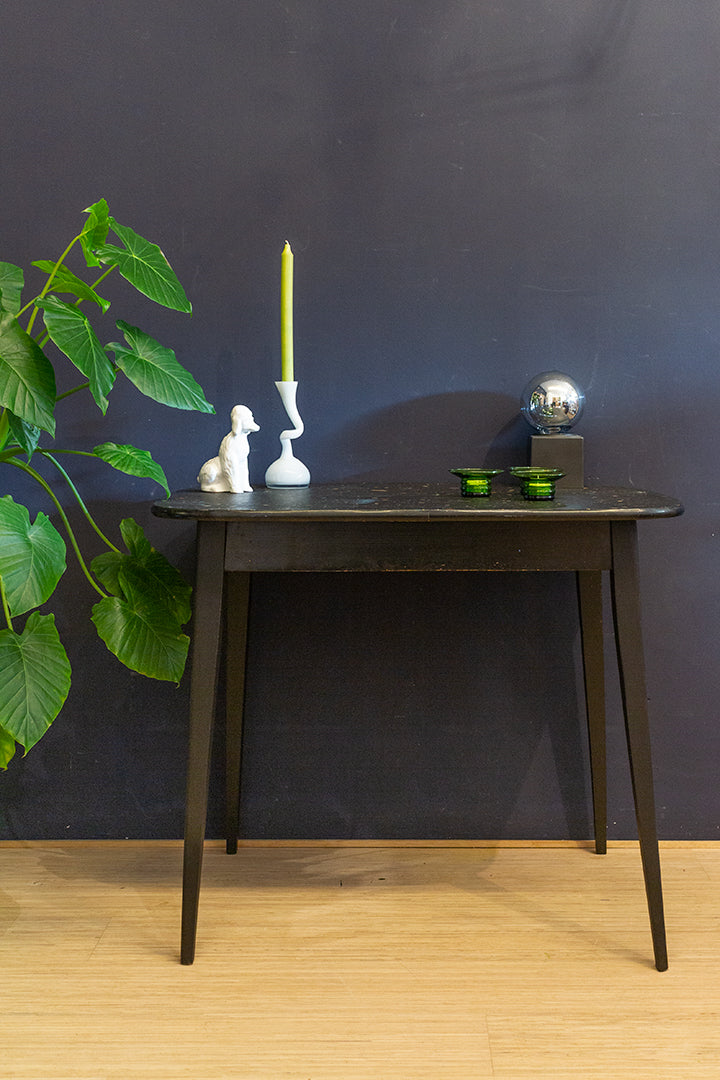 Vintage zwarte eettafel met gekleurd confetti blad