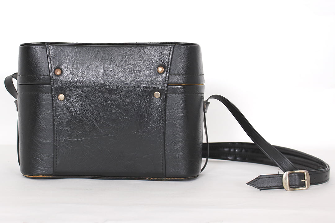 Zwarte vintage camerakoffer met gele voering